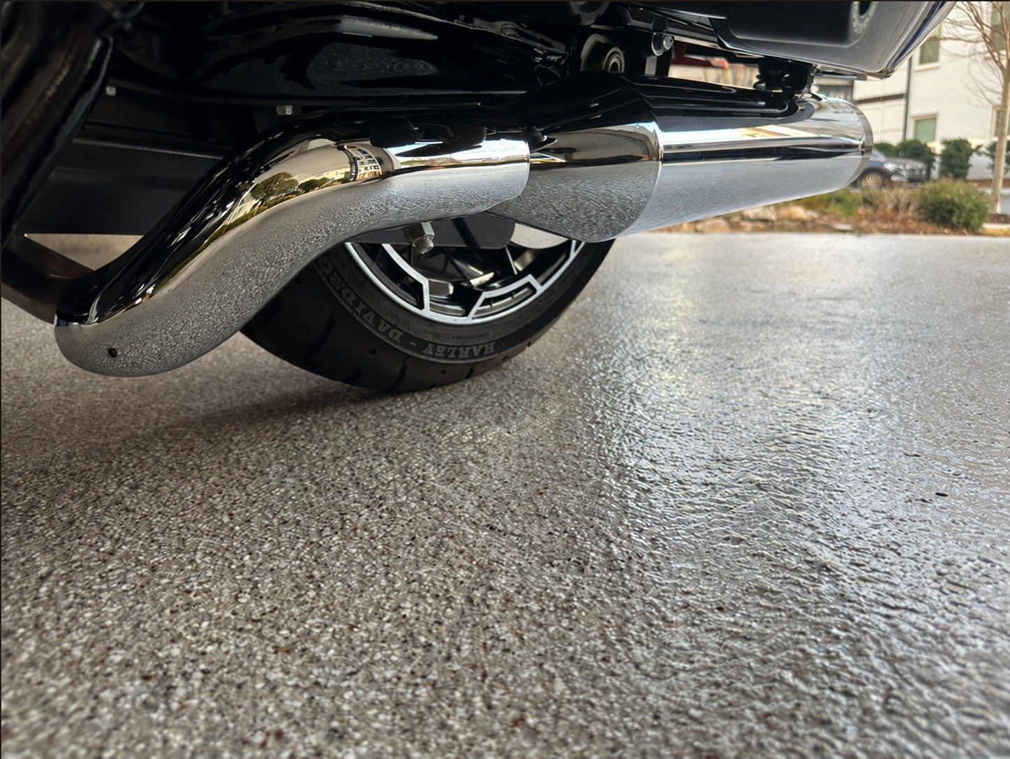 Motorcycle exhaust over a glossy flake garage floor