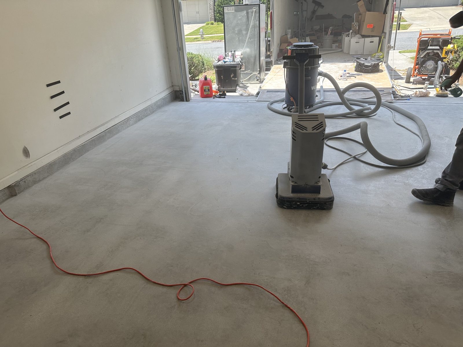 Diamond grinder and vacuum in a garage