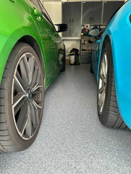 Coated garage floor between two BMWs